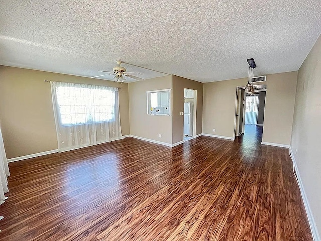 unfurnished room featuring a textured ceiling, ceiling fan, and dark wood-type flooring