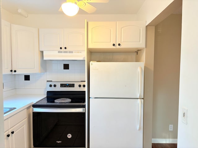 kitchen with decorative backsplash, wood-type flooring, white refrigerator, white cabinets, and stainless steel electric range oven