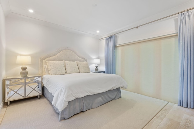 bedroom with crown molding and hardwood / wood-style floors