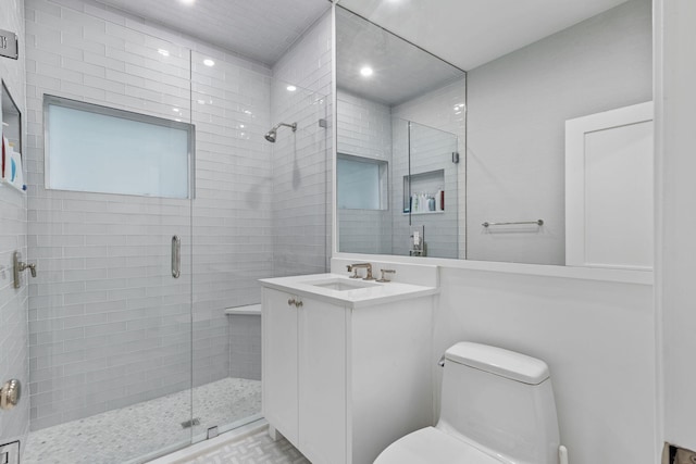 bathroom with vanity, an enclosed shower, and toilet