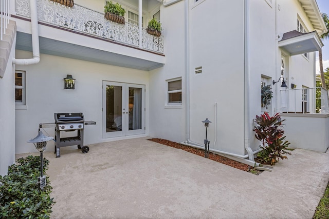 exterior space with french doors and a balcony