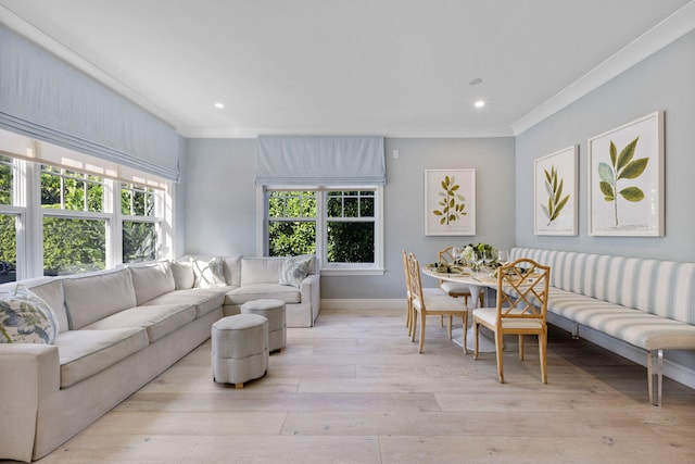 living room featuring light hardwood / wood-style flooring and crown molding