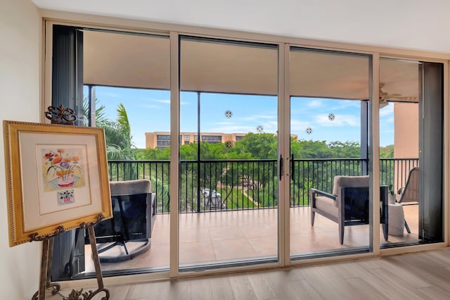 doorway to outside with hardwood / wood-style flooring and a wealth of natural light