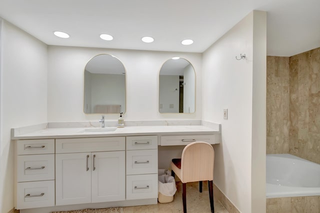 bathroom featuring vanity, tiled bath, and tile patterned floors