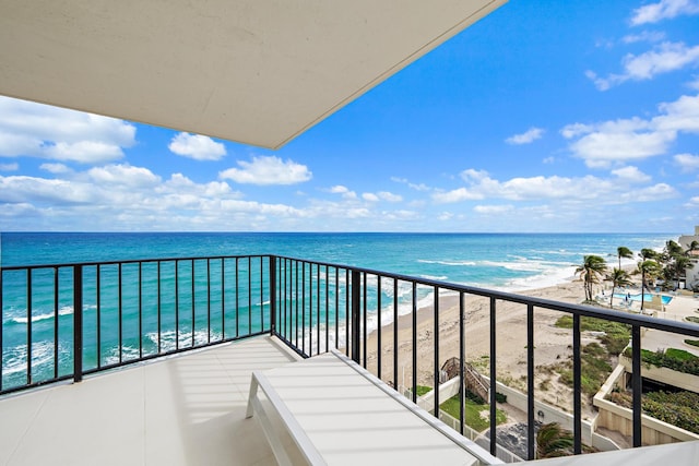 balcony with a water view and a beach view