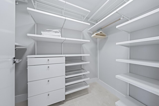 spacious closet with light tile patterned flooring