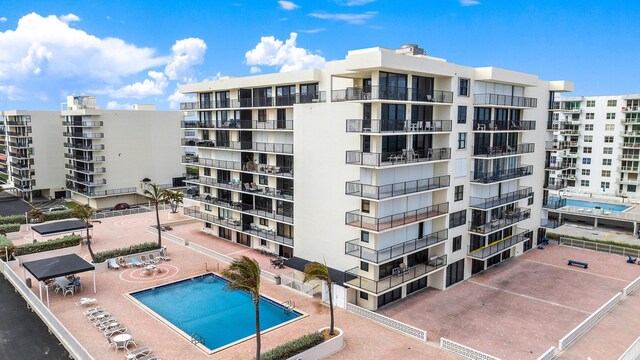 view of building exterior with a community pool