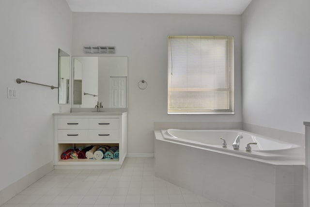 bathroom with tiled bath, tile patterned flooring, and vanity