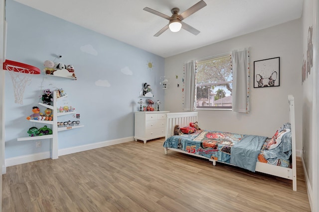 bedroom with ceiling fan and light hardwood / wood-style flooring