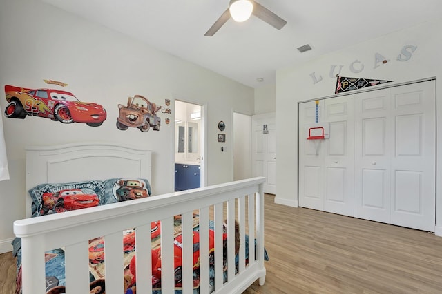 bedroom featuring a closet, hardwood / wood-style floors, and ceiling fan