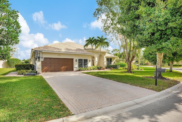 view of front of property featuring a garage and a front yard