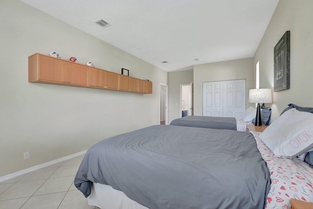 tiled bedroom featuring a closet