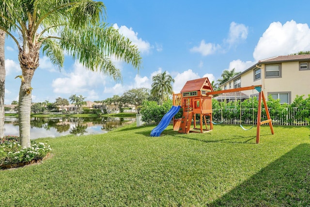 view of jungle gym with a yard and a water view