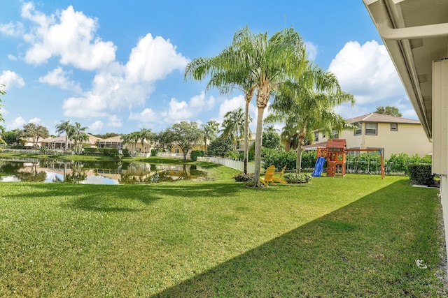 view of yard featuring a playground and a water view