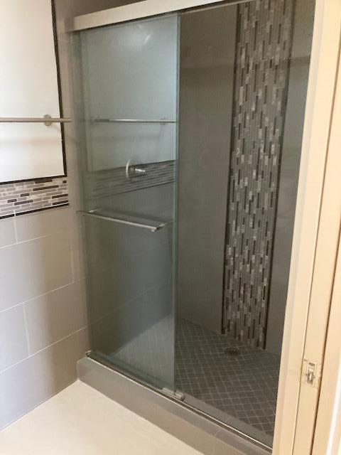 bathroom featuring a shower with shower door