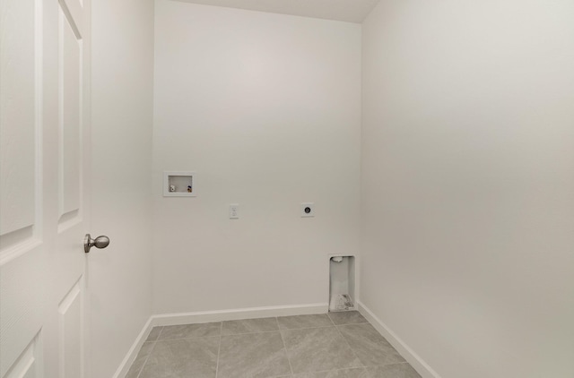 clothes washing area featuring hookup for an electric dryer, washer hookup, and light tile patterned floors