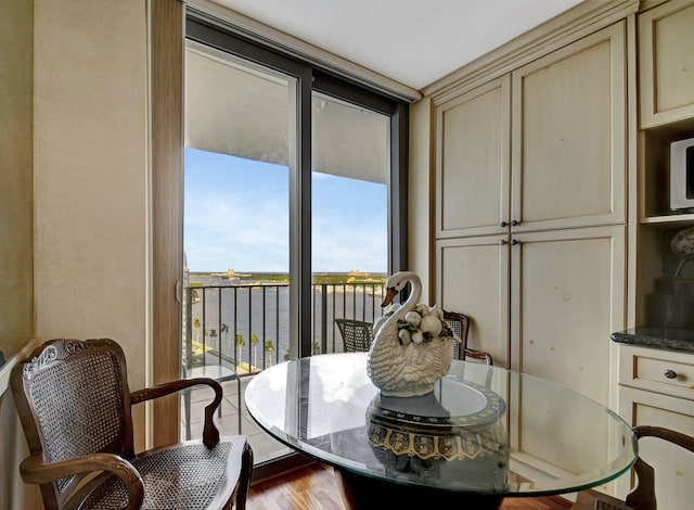 dining space featuring a water view and light hardwood / wood-style flooring