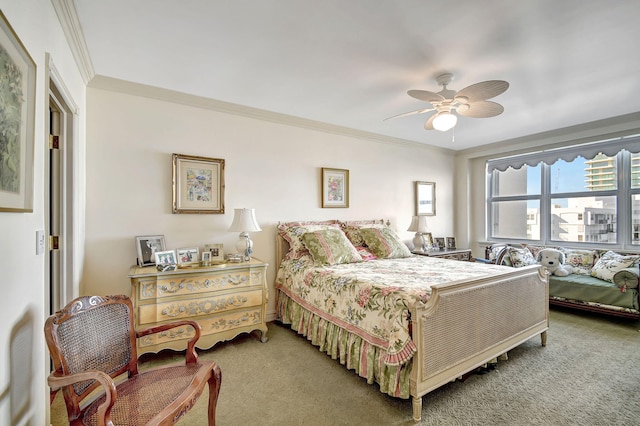 carpeted bedroom with ceiling fan and ornamental molding