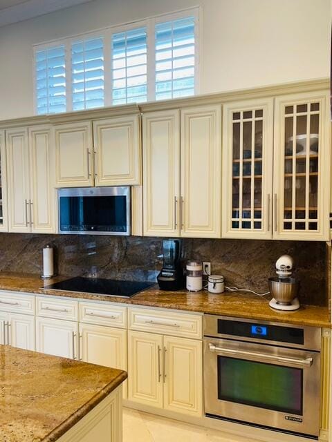 kitchen featuring cream cabinetry, a wealth of natural light, sink, and appliances with stainless steel finishes