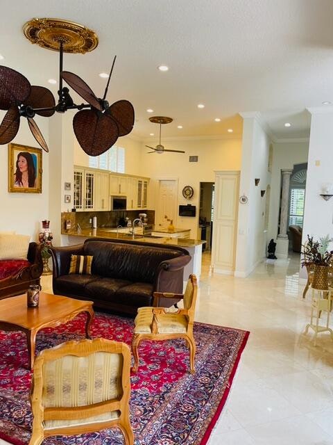 spare room featuring ceiling fan, light hardwood / wood-style floors, ornamental molding, and french doors