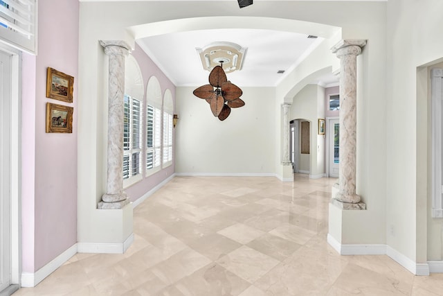 hallway featuring ornate columns and crown molding