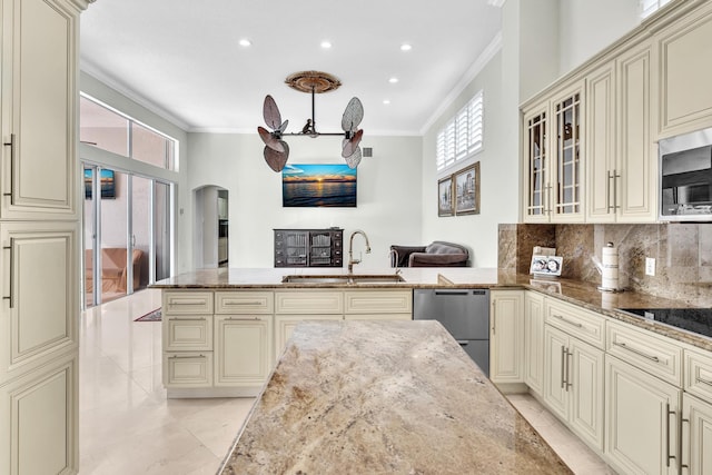 kitchen featuring cream cabinets, sink, and light stone countertops