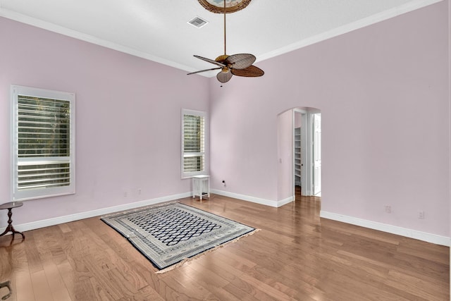 spare room with hardwood / wood-style floors, ceiling fan, and ornamental molding