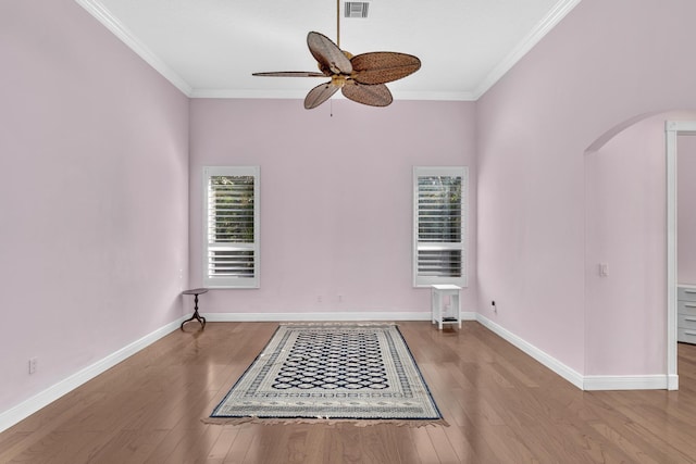 unfurnished room with ceiling fan, wood-type flooring, and ornamental molding