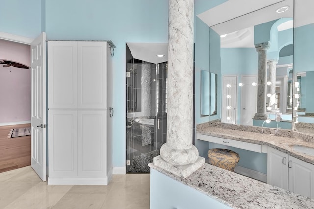 bathroom featuring vanity, ornate columns, and walk in shower