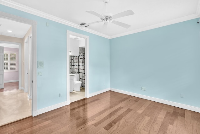 unfurnished bedroom with connected bathroom, hardwood / wood-style flooring, ceiling fan, and crown molding