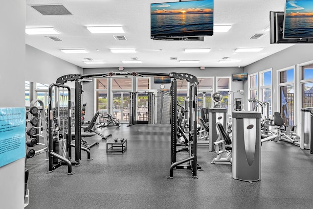 exercise room with a healthy amount of sunlight and a textured ceiling