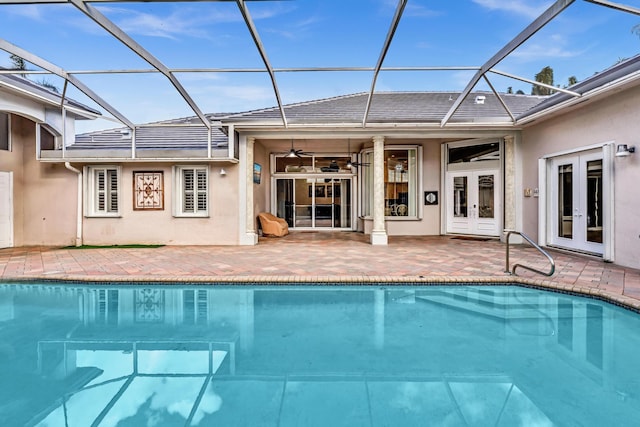 view of pool featuring a lanai, ceiling fan, french doors, and a patio