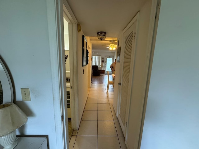 hall with light tile patterned floors