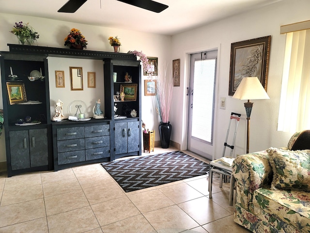 tiled foyer featuring ceiling fan