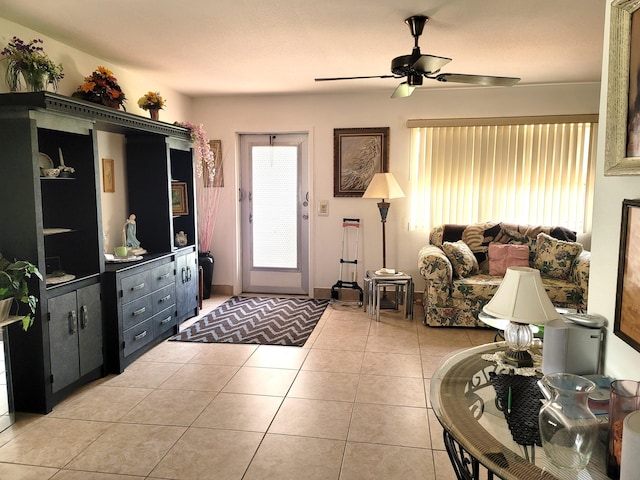 tiled living room featuring ceiling fan