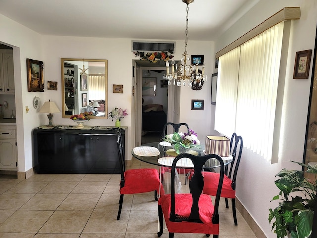 tiled dining area with a chandelier