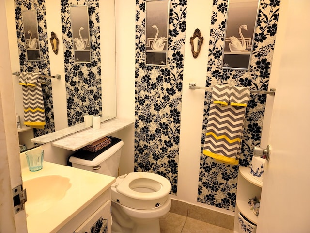 bathroom with tile patterned flooring, vanity, and toilet