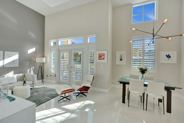 tiled living room with a notable chandelier and a towering ceiling