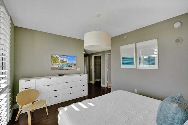 bedroom with dark hardwood / wood-style flooring