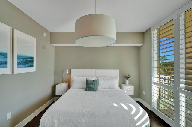 bedroom with dark wood-type flooring