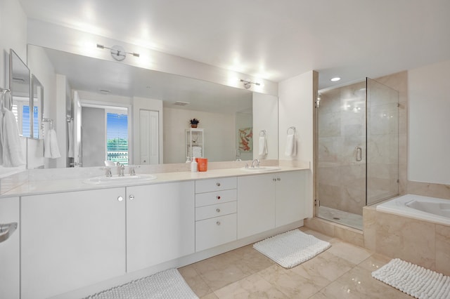 bathroom featuring vanity and independent shower and bath