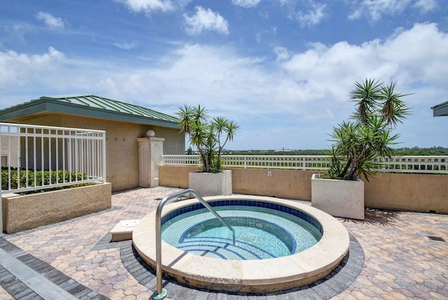 view of pool with an in ground hot tub and a patio