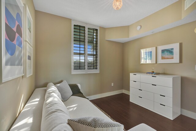 living room with plenty of natural light and dark wood-type flooring