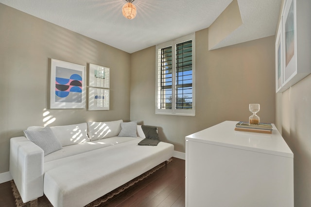 bedroom with dark hardwood / wood-style flooring and a textured ceiling