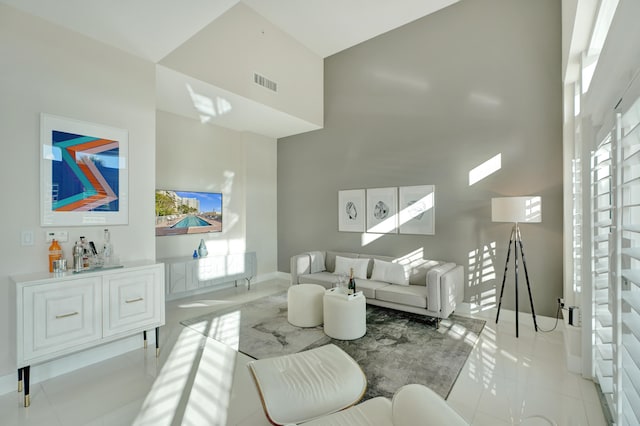 tiled living room with a high ceiling