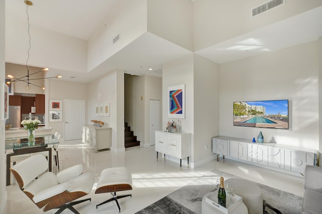 living room featuring a high ceiling and a chandelier