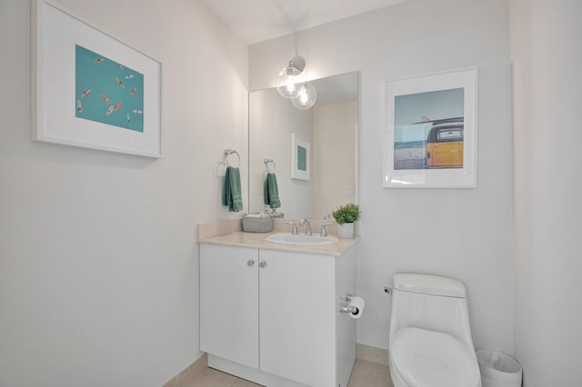 bathroom featuring toilet, vanity, and tile patterned floors