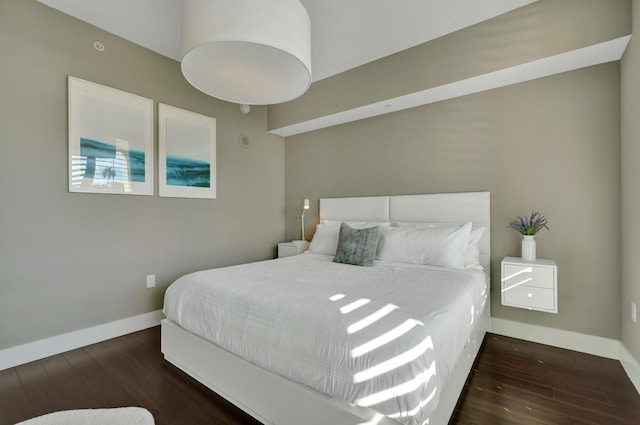 bedroom with dark wood-type flooring