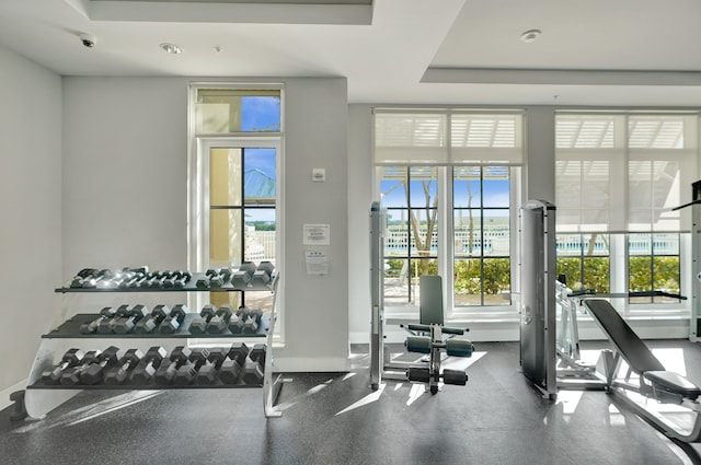 gym with a tray ceiling