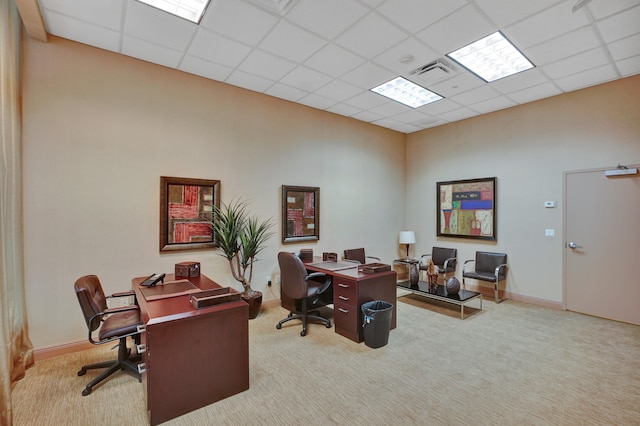 carpeted office with a drop ceiling